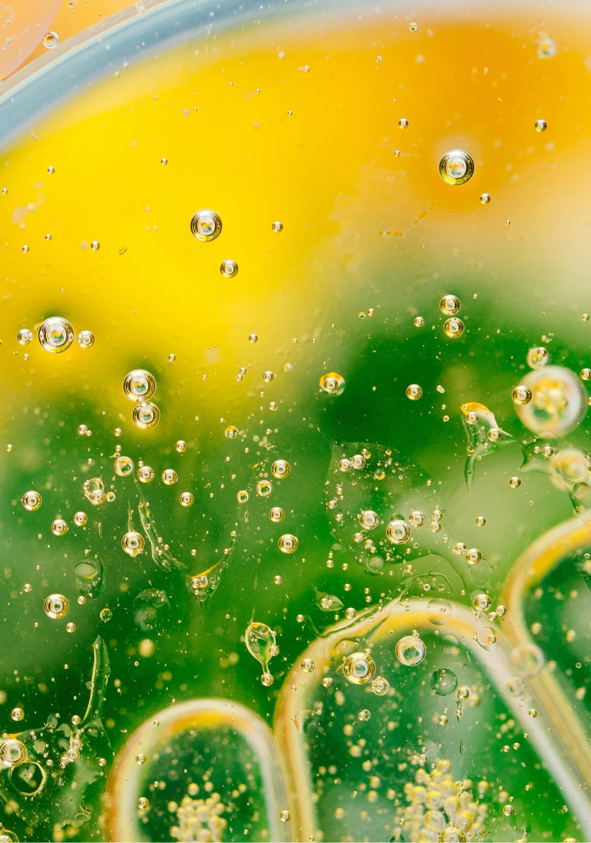 Macro photo of green and yellow liquids combining together